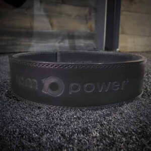 The RPM Power Powerlifting Belt with logo on a black carpet.