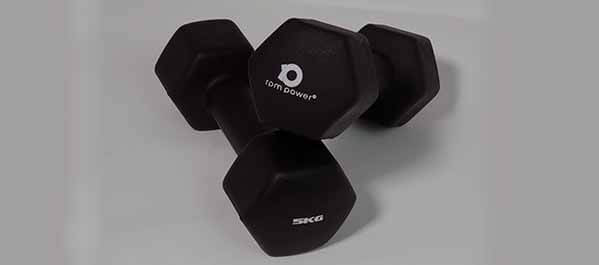 A pair of black neoprene dumbbells against a white background