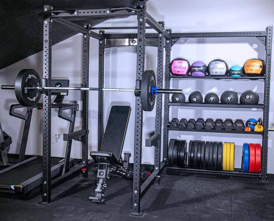 Power Rack with Storage, including a weight bench, dumbbells, kettlebell, weight plates, olympic barbell and wall balls, slam balls and medicine balls