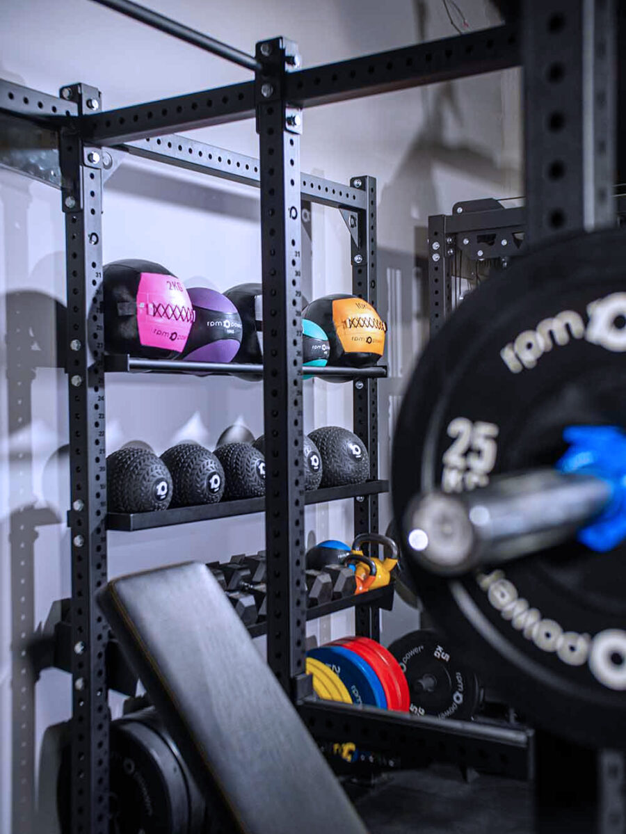 Power Rack with Storage, including a weight bench, dumbbells, kettlebell, weight plates, olympic barbell and wall balls, slam balls and medicine balls
