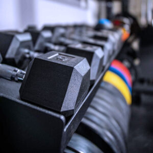 close up of hex dumbbells on squat rack