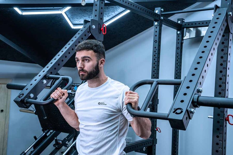 Man with Jammer Arms Pair Exercising on Power Rack