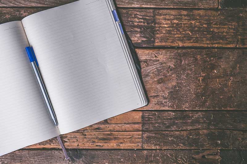 A journal notebook and pen on a table