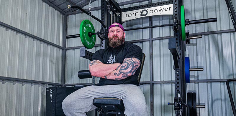 Pa O Dwyer sitting on U3800 weight bench with Ragnar multi-gym in the background