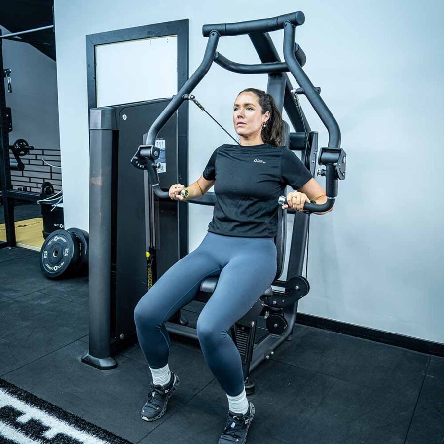 Woman Using Chest Press Machine