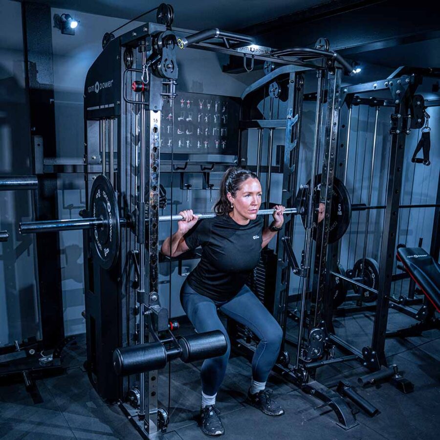 Woman using Multigym with Smith Bar, Weight Stack and Pull Up bar