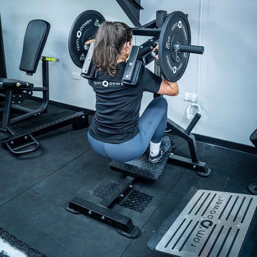 Woman Using Pendulum Squat Machine