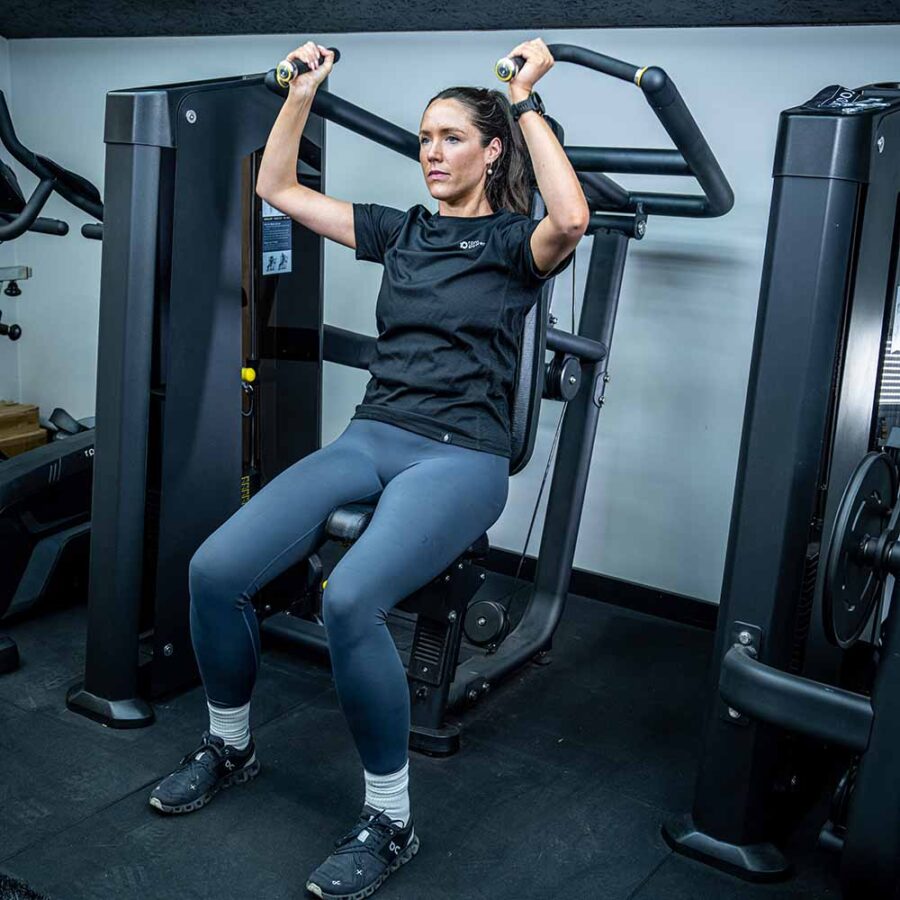 Woman Using Shoulder Press Machine