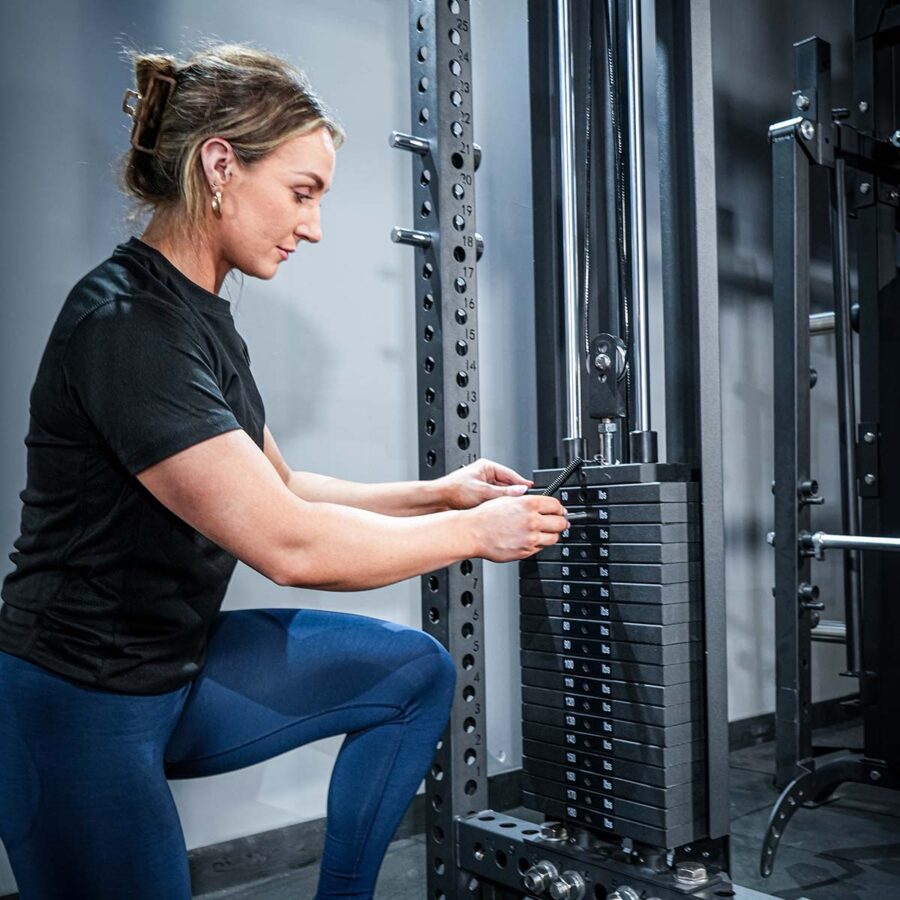 Woman using Multi-Gym with Cable Machine, Smith Bar & Pull-Up BAR