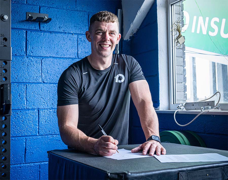 Ronan Maher signing a contract on a RPM Plyo Box