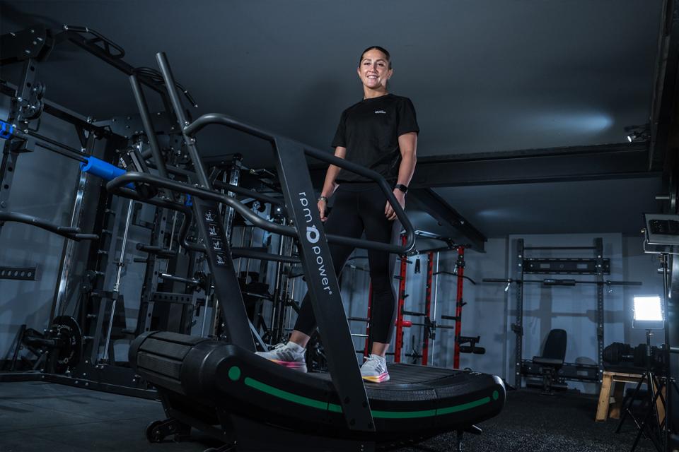 Amee-Leigh Murphy Crowe standing on an Air Runner Treadmill