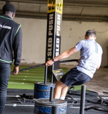 A man pulling a sled with RPM Power weight plates