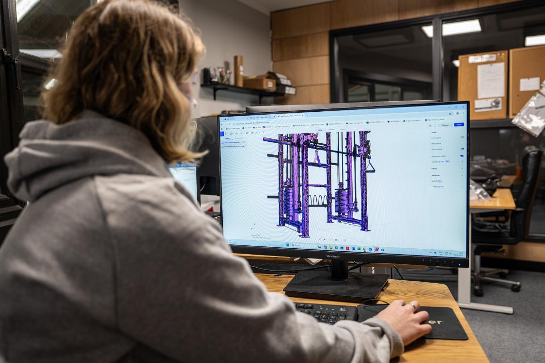 a woman using a computer to design a product