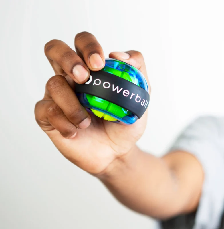 A man holding a 280Hz Pro Blue Powerball in his hand