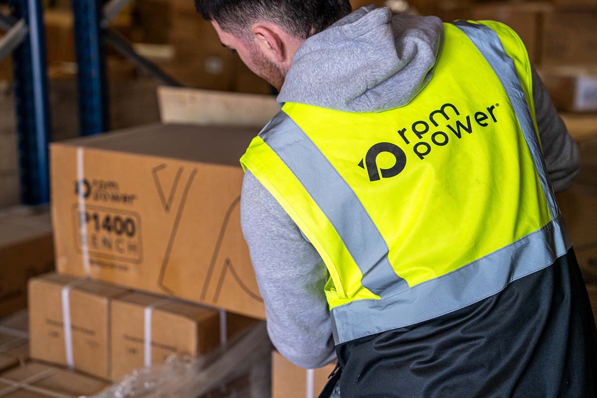 A man in a hi-vis jacket with rpm power branding