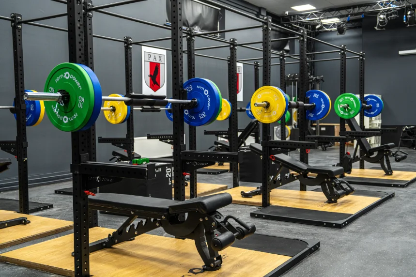 A full gym outfit with racks, benches and weight plates