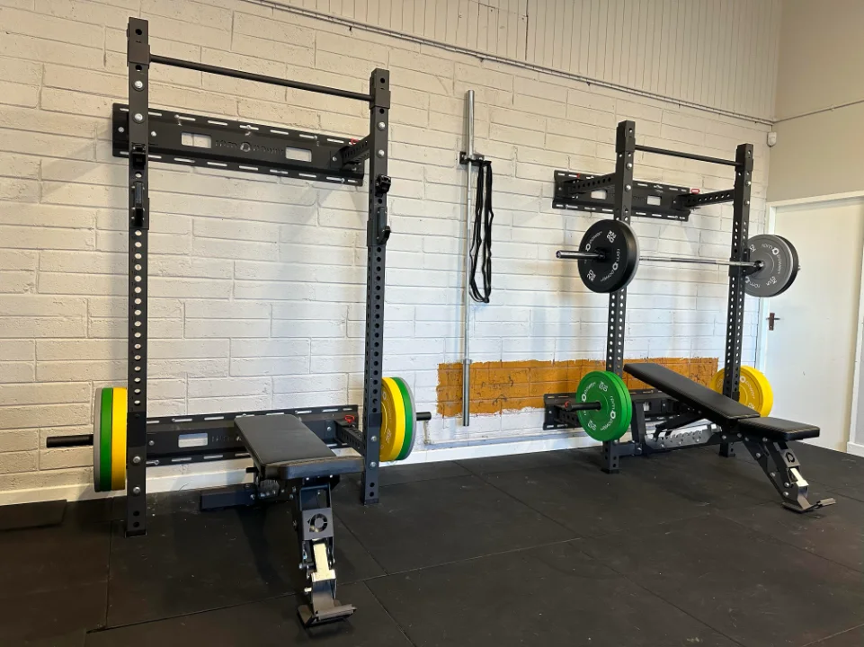 Wall-mounted squat racks in a gym