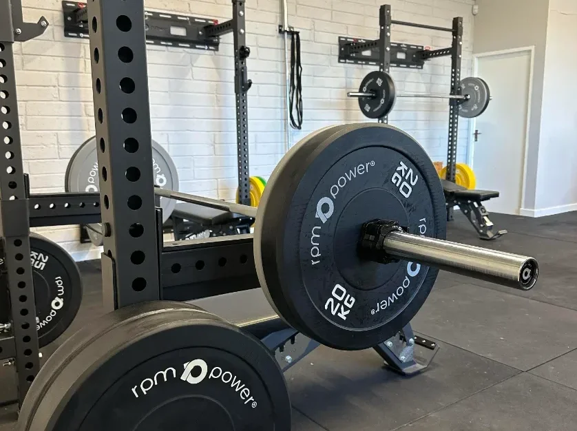 Weight plates from RPM Power on a squat rack