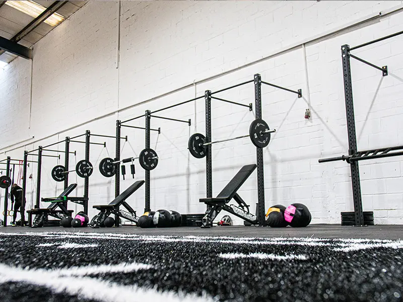 Racks and rigs in Unit 3 gym with turf flooring