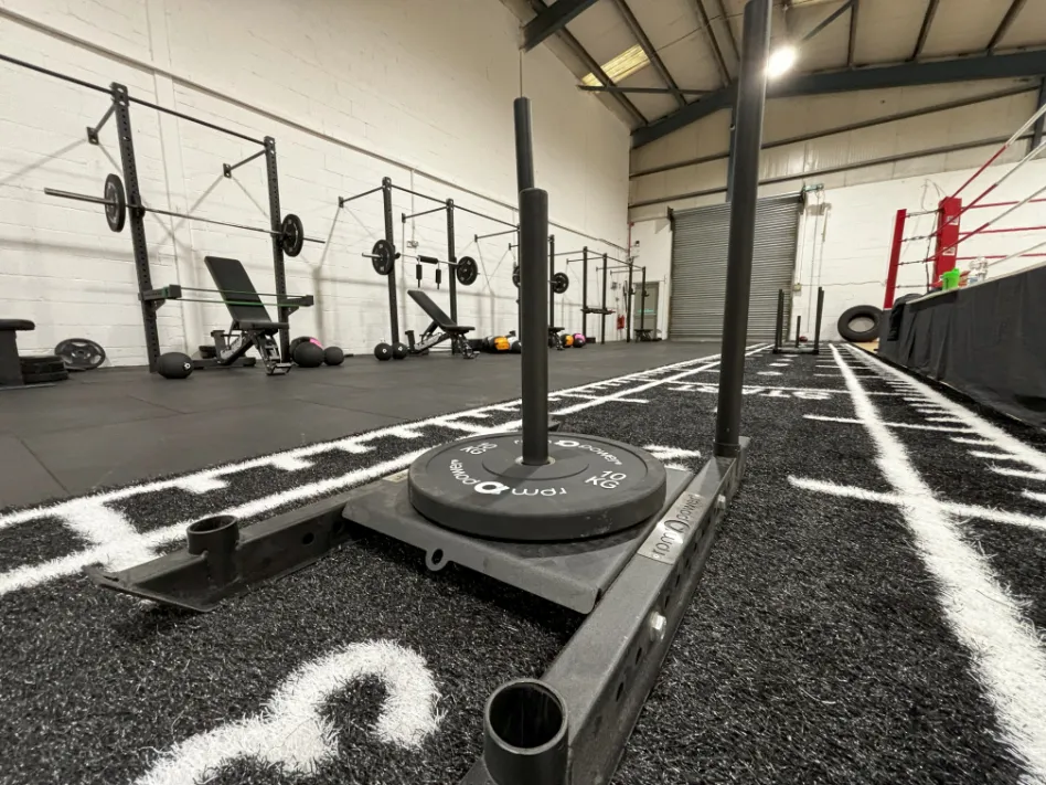 A RPM Power Sled with weight plates in a gym