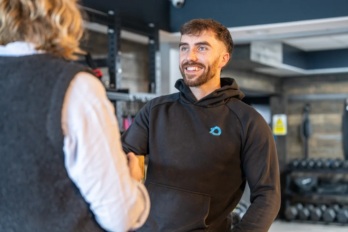 A man shaking the hand of a woman
