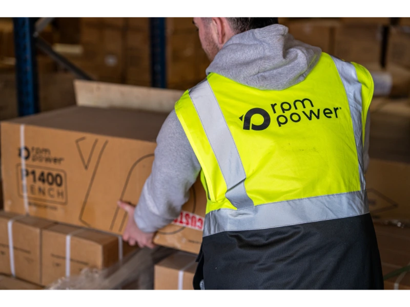 A man in a hi-vis jacket with rpm power branding