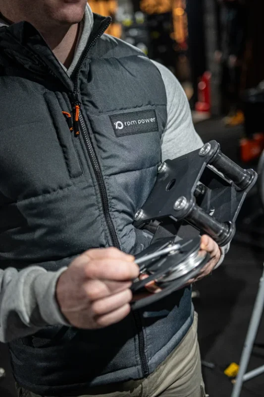A man repairing a piece of fitness equipment