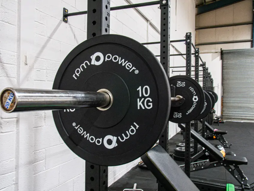 RPM Power weight plate 10kg on a barbell and rack
