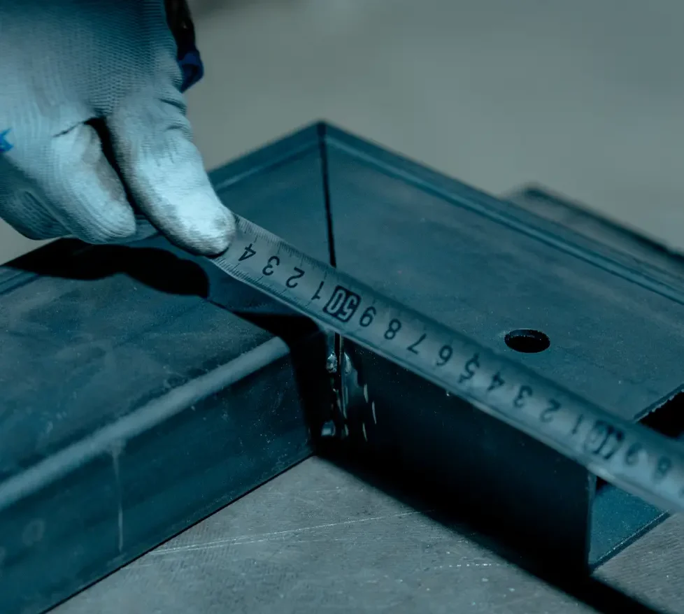 A person measuring a piece of metal