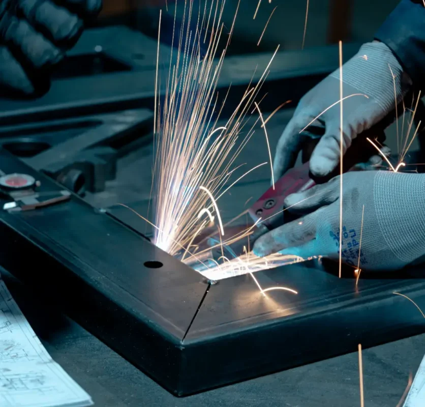 A person welding some metal