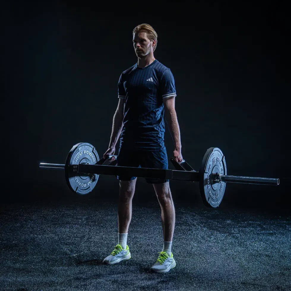 Caoimhin Kelleher with a barbell and weight plates