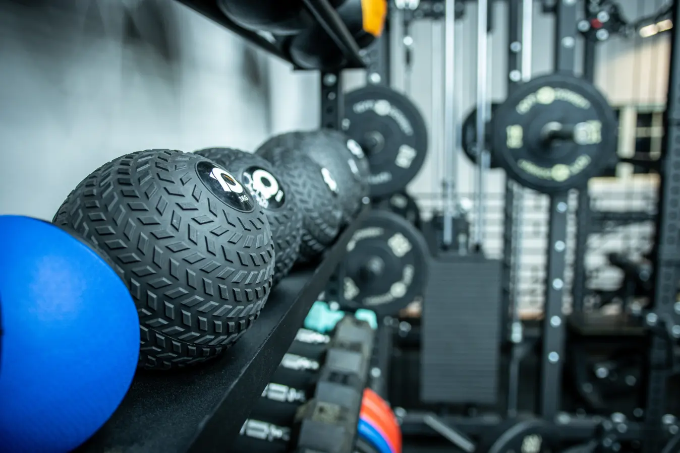 Slam balls and weight plates in a gym