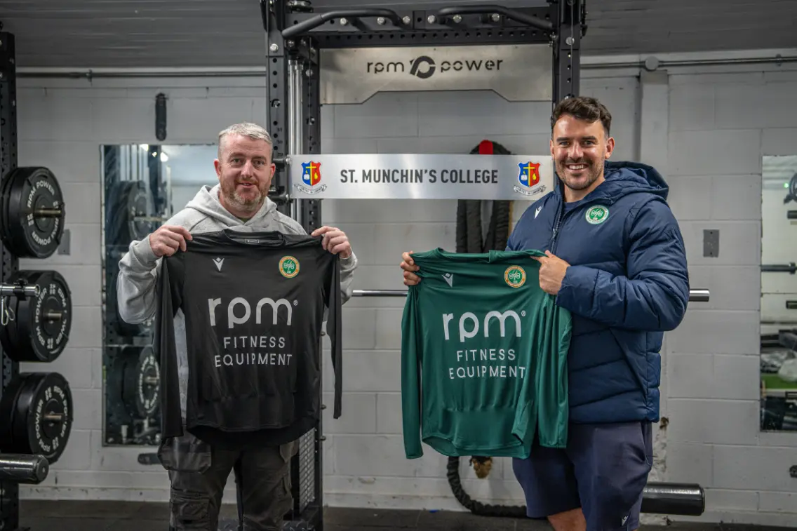 Two men holding rugby jerseys